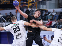 Jonathan Sandell Lukas Peter (17) and Patrik Ligetvari (23) of Veszprem HC battle for the ball with Ahmed Abdelhamid (29) of Zamalek Club du...