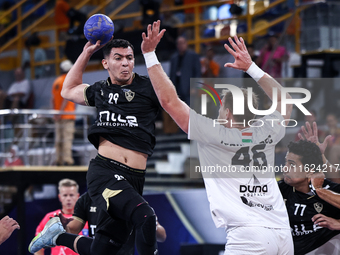 Jacques Pechmalbec of Veszprem HC battles for the ball with Ahmed Abdelhamid of Zamalek Club during the IHF Men's Handball Club World Champi...