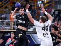 Jacques Pechmalbec of Veszprem HC battles for the ball with Ahmed Abdelhamid of Zamalek Club during the IHF Men's Handball Club World Champi...