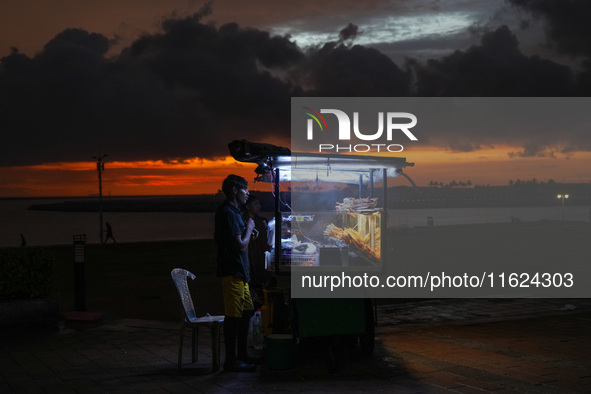 A street food vendor waits for customers at Galle Face promenade in Colombo, Sri Lanka, on September 30, 2024. 