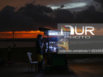 A street food vendor waits for customers at Galle Face promenade in Colombo, Sri Lanka, on September 30, 2024. (