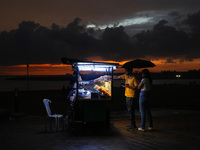 A street food vendor sells street food to customers at Galle Face promenade in Colombo, Sri Lanka, on September 30, 2024. (