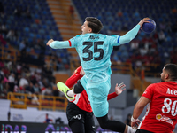 Domen Makuc of FC Barcelona tries to score during the 17th IHF Men's Club World Championship 2024 preliminary round match between Al Ahly Sp...