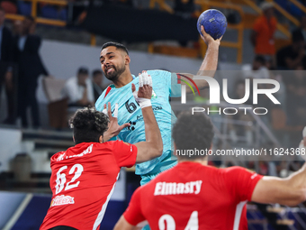 Mohamed Magdy of Al Ahly SC battles for the ball with Melvyn Richardson of FC Barcelona during the 17th IHF Men's Club World Championship 20...