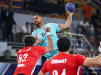 Mohamed Magdy of Al Ahly SC battles for the ball with Melvyn Richardson of FC Barcelona during the 17th IHF Men's Club World Championship 20...