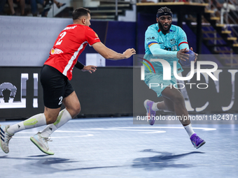 Sheref Nabil of Al Ahly SC battles for the ball with Dika Mem of FC Barcelona during the 17th IHF Men's Club World Championship 2024 prelimi...