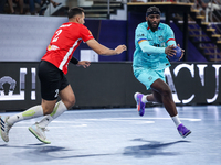 Sheref Nabil of Al Ahly SC battles for the ball with Dika Mem of FC Barcelona during the 17th IHF Men's Club World Championship 2024 prelimi...