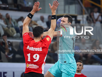 19 Omar Dahroug of Al Ahly SC battles for the ball with 13 Aitor Arino Bengoechea of FC Barcelona during the 17th IHF Men's Club World Champ...