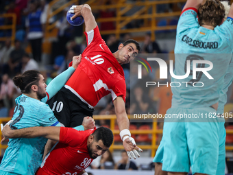 10 Abd Elrahman Abdou of Al Ahly SC battles for the ball with 82 Luis Diogo Da Sousa Frade of FC Barcelona during the 17th IHF Men's Club Wo...