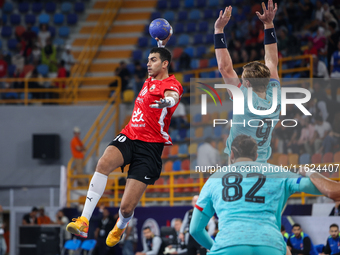 10 Abd Elrahman Abdou of Al Ahly SC battles for the ball with 9 Jonathan Carlsbogard of FC Barcelona during the 17th IHF Men's Club World Ch...