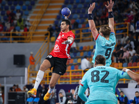 10 Abd Elrahman Abdou of Al Ahly SC battles for the ball with 9 Jonathan Carlsbogard of FC Barcelona during the 17th IHF Men's Club World Ch...