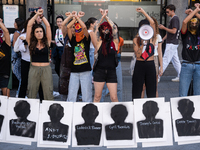 A dozen feminist activists perform with the names of some of Gisele Pelicot's rapists and with the message she recently said: ''Let shame ch...