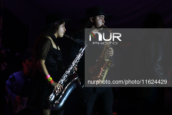 Members of the Orquesta Internacional band perform during the ''Hasta Siempre Presidente Fest'' at the Monumento to the Revolution in Mexico...