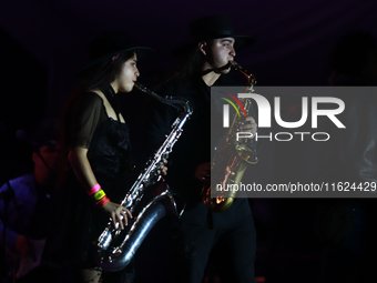 Members of the Orquesta Internacional band perform during the ''Hasta Siempre Presidente Fest'' at the Monumento to the Revolution in Mexico...