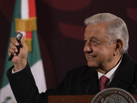 Andres Manuel Lopez Obrador, President of Mexico, gives his watch to a journalist during his last press conference at the National Palace in...