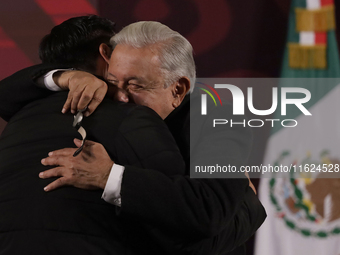 Andres Manuel Lopez Obrador, President of Mexico, gives his watch to a journalist during his last press conference at the National Palace in...