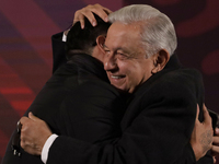 Andres Manuel Lopez Obrador, President of Mexico, gives his watch to a journalist during his last press conference at the National Palace in...