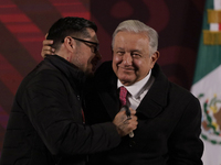 Andres Manuel Lopez Obrador, President of Mexico, gives his watch to a journalist during his last press conference at the National Palace in...