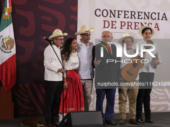 Andres Manuel Lopez Obrador, President of Mexico, says goodbye to the musical group Mono Blanco during his last press conference in Mexico C...