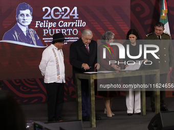 Andres Manuel Lopez Obrador, President of Mexico, signs an agreement with his team during a press conference in Mexico City, Mexico, on Sept...