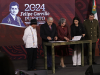 Andres Manuel Lopez Obrador, President of Mexico, signs an agreement with his team during a press conference in Mexico City, Mexico, on Sept...