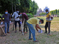 Workers use pesticides at a burrow to get rid of rats during a two-day campaign by Jaipur Development Authority to wipe out rodents at Alber...