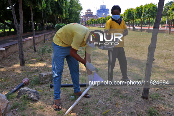 Workers use pesticides at a burrow to get rid of rats during a two-day campaign by Jaipur Development Authority to wipe out rodents at Alber...