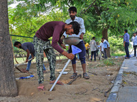 Workers use pesticides at a burrow to get rid of rats during a two-day campaign by Jaipur Development Authority to wipe out rodents at Alber...