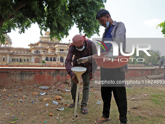 Workers use pesticides at a burrow to get rid of rats during a two-day campaign by Jaipur Development Authority to wipe out rodents at Alber...