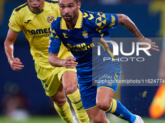 Benito Ramirez del Toro of UD Las Palmas competes for the ball with Ilias Akhomach of Villarreal CF during the LaLiga EA Sports match betwee...