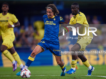 Fabio Daniel Soares Silva of UD Las Palmas competes for the ball with Eric Bailly of Villarreal CF during the LaLiga EA Sports match between...