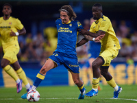 Fabio Daniel Soares Silva of UD Las Palmas competes for the ball with Eric Bailly of Villarreal CF during the LaLiga EA Sports match between...