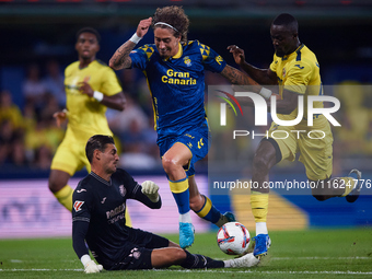 Fabio Daniel Soares Silva of UD Las Palmas competes for the ball with Eric Bailly and Diego Conde of Villarreal CF during the LaLiga EA Spor...