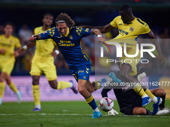 Fabio Daniel Soares Silva of UD Las Palmas competes for the ball with Eric Bailly and Diego Conde of Villarreal CF during the LaLiga EA Spor...