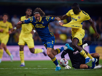 Fabio Daniel Soares Silva of UD Las Palmas competes for the ball with Eric Bailly and Diego Conde of Villarreal CF during the LaLiga EA Spor...