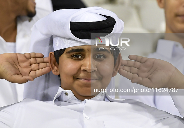 A fan of Al Sadd SC cheers for their team during the AFC Champions League elite west football match between Qatar's Al Sadd SC and Iran's Es...