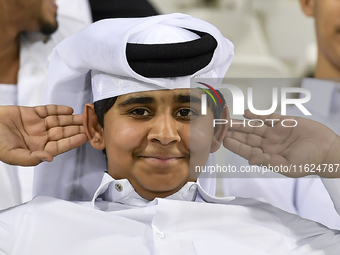 A fan of Al Sadd SC cheers for their team during the AFC Champions League elite west football match between Qatar's Al Sadd SC and Iran's Es...