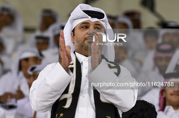 A fan of Al Sadd SC cheers for their team during the AFC Champions League elite west football match between Qatar's Al Sadd SC and Iran's Es...