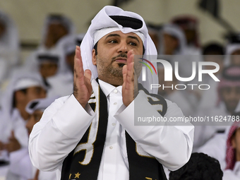 A fan of Al Sadd SC cheers for their team during the AFC Champions League elite west football match between Qatar's Al Sadd SC and Iran's Es...