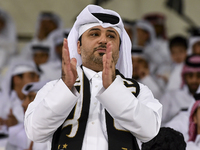 A fan of Al Sadd SC cheers for their team during the AFC Champions League elite west football match between Qatar's Al Sadd SC and Iran's Es...