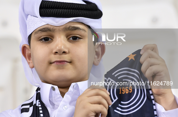 A fan of Al Sadd SC cheers for their team during the AFC Champions League elite west football match between Qatar's Al Sadd SC and Iran's Es...