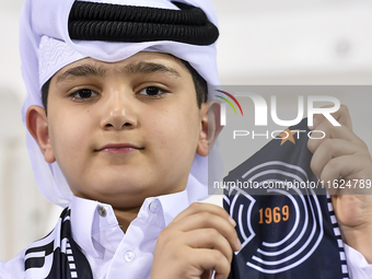 A fan of Al Sadd SC cheers for their team during the AFC Champions League elite west football match between Qatar's Al Sadd SC and Iran's Es...