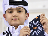 A fan of Al Sadd SC cheers for their team during the AFC Champions League elite west football match between Qatar's Al Sadd SC and Iran's Es...