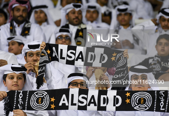 Fans of Al Sadd SC cheer for their team during the AFC Champions League elite west football match between Qatar's Al Sadd SC and Iran's Este...