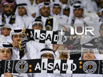 Fans of Al Sadd SC cheer for their team during the AFC Champions League elite west football match between Qatar's Al Sadd SC and Iran's Este...