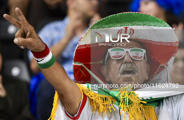 A fan of Esteghlal FC cheers for their team during the AFC Champions League elite west football match between Qatar's Al Sadd SC and Iran's...