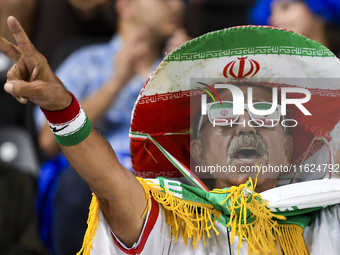 A fan of Esteghlal FC cheers for their team during the AFC Champions League elite west football match between Qatar's Al Sadd SC and Iran's...