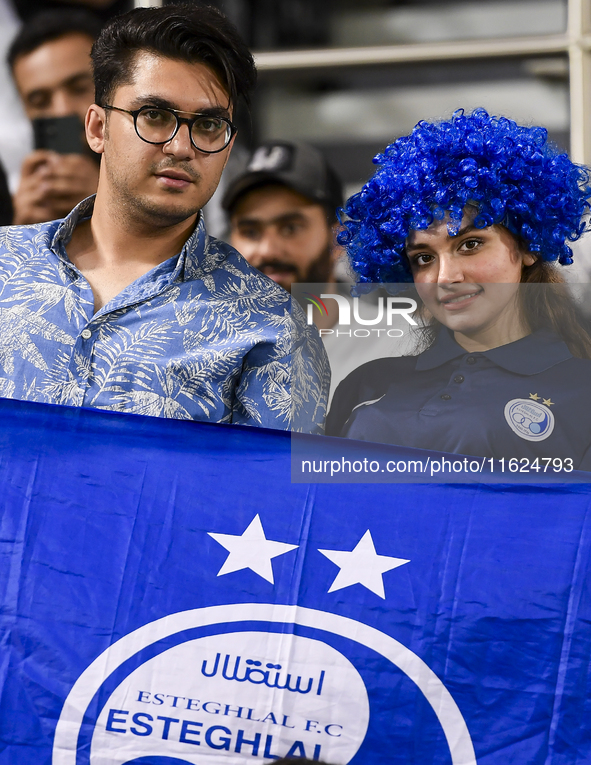 Fans of Esteghlal FC cheer for their team during the AFC Champions League elite west football match between Qatar's Al Sadd SC and Iran's Es...