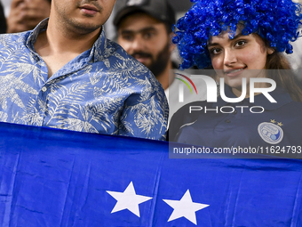 Fans of Esteghlal FC cheer for their team during the AFC Champions League elite west football match between Qatar's Al Sadd SC and Iran's Es...