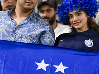 Fans of Esteghlal FC cheer for their team during the AFC Champions League elite west football match between Qatar's Al Sadd SC and Iran's Es...